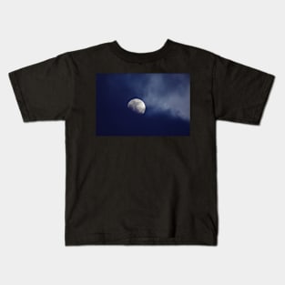 Moon behind dark blue clouds Kids T-Shirt